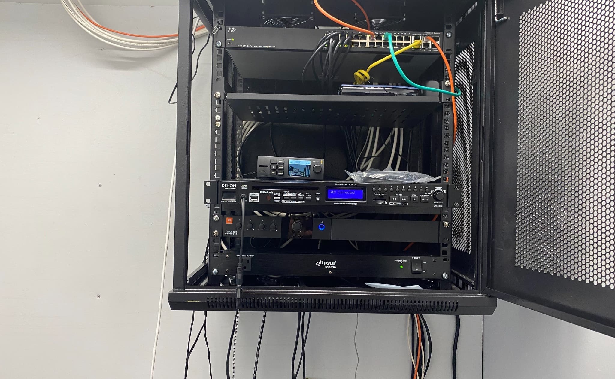 Integrated network and AV equipment rack in a funeral home
